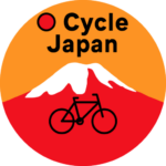 O Cycle Japan logo with orange background, red mountain with white cap and outline of a bicycle in the front with the name.