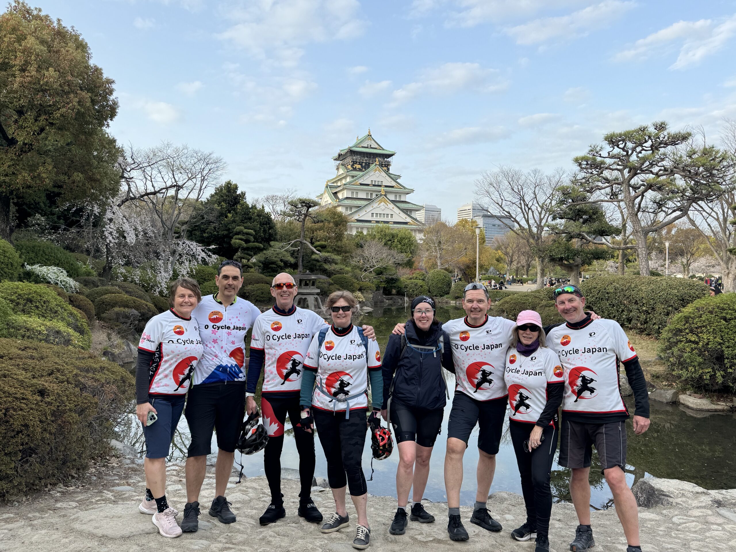 Osaka Castle with cyclists posing in the foreground