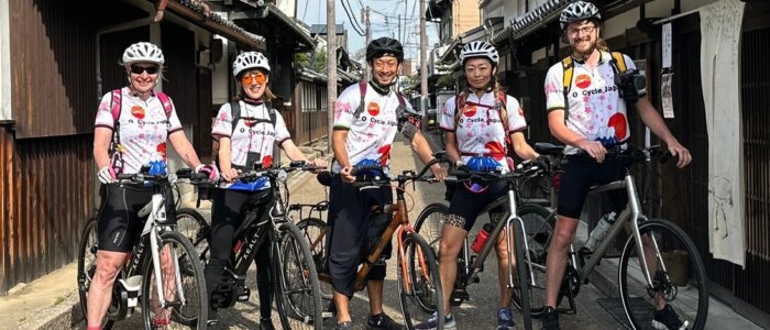 Group of O Cycle Japan cyclists pose for a photo in the old traditional town of Imaicho.