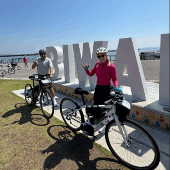 Cyclists pose in front of Biwa Lake a beautiful and popular cycling location in Japan.
