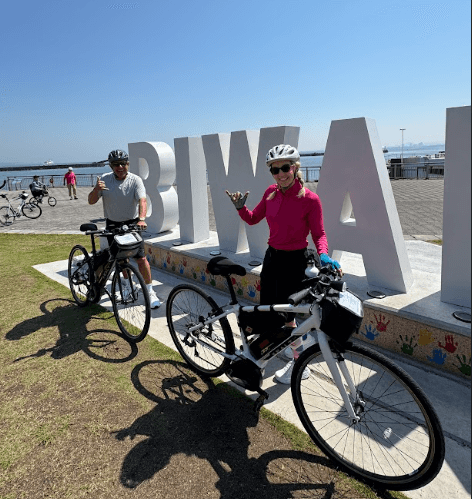 Cyclists pose in front of Biwa Lake a beautiful and popular cycling location in Japan.